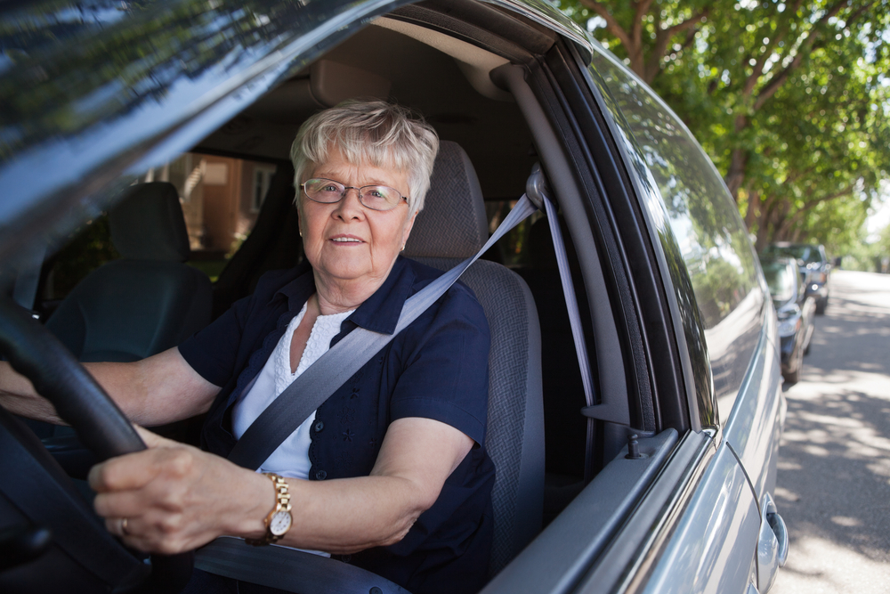 Senior woman driving car. How long after cataract surgery can you drive?